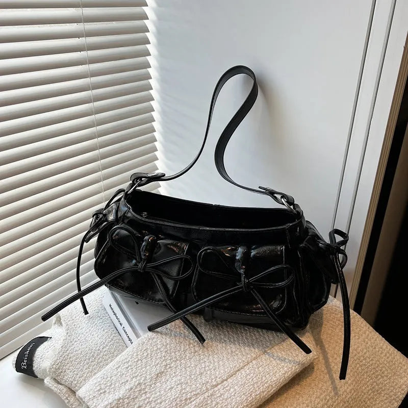 Women's tassel bow shoulder bag showing pleated design and multiple pockets, available in eight colours