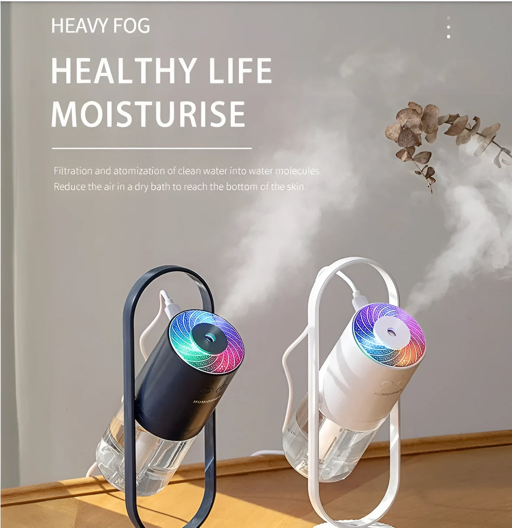Pink USB portable air humidifier with projection night light on a wooden desk