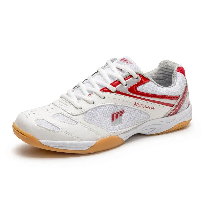 White and red table tennis sneakers with synthetic leather upper and lace-up front.