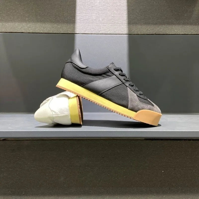 Men's black summer sports shoes with mesh panels, suede leather, and a herringbone pattern on the toe.