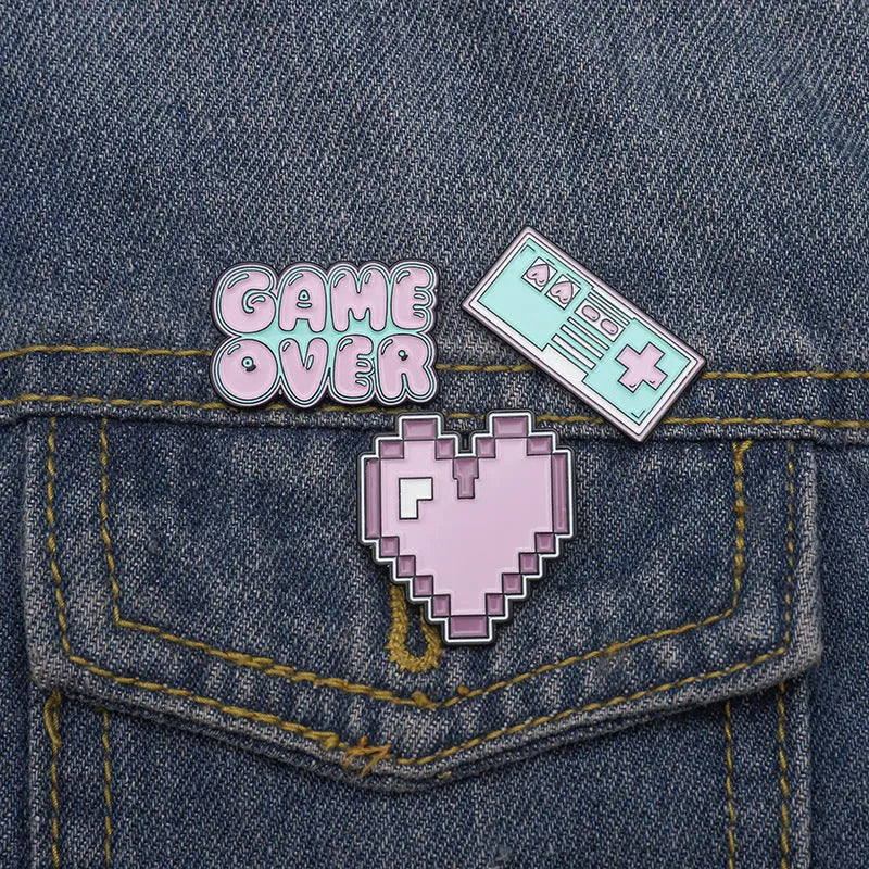 Three-dimensional alloy game console badge in metallic finish with mounting points