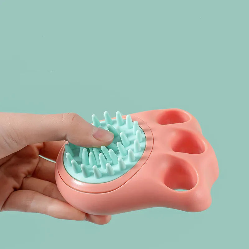 Blue pet bath and massage brush with soft silicone bristles and a plastic handle for cats and dogs.