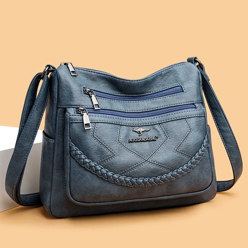 Black soft PU leather shoulder bag with crossbody strap, showing 30cm width and zippered internal organiser