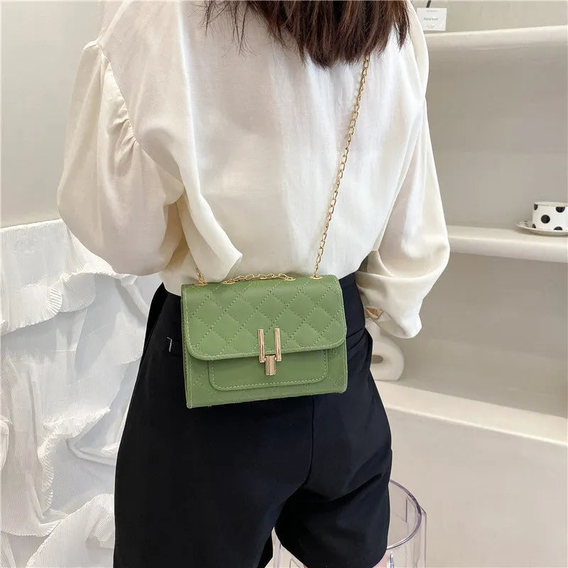 Women's crossbody bag with diamond lattice pattern, adjustable 120cm strap, shown in black colour with dimensions 17.5cm width