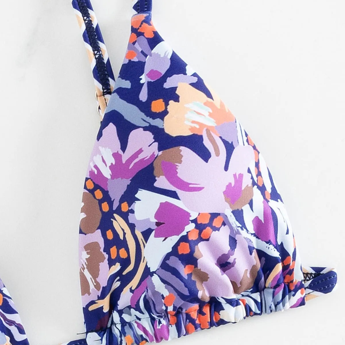 Women's floral print triangle bikini with tie-back and split-front polyester briefs.