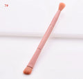 10 cosmetic brushes with wooden handles and nylon bristles arranged with makeup products