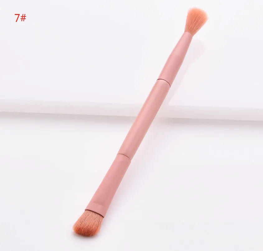 10 cosmetic brushes with wooden handles and nylon bristles arranged with makeup products