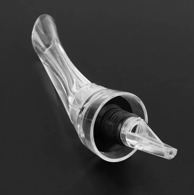 Wine aerator with stainless steel filter, measuring 16cm in length and 4.2cm in diameter, on a glass with red wine.