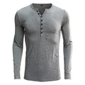 Men's long sleeved blue Henry collar pullover shirt laid flat, showing cotton blend fabric texture.