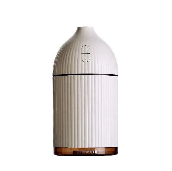White ultrasonic aromatherapy diffuser with LED light, 300ml capacity, and USB cable on a wooden table