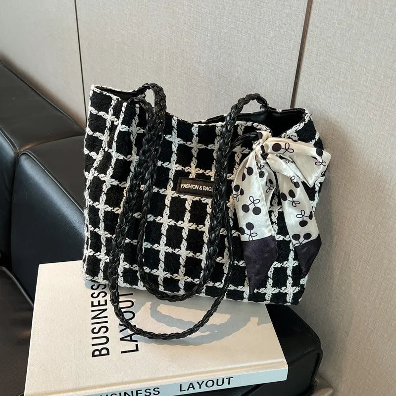 Black woolen shoulder bag with horizontal square shape showing internal organisation compartments