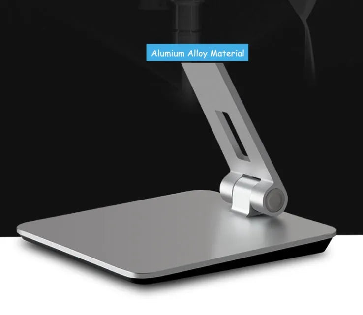 Silver foldable desktop holder supporting tablet with 360° rotation mechanism visible