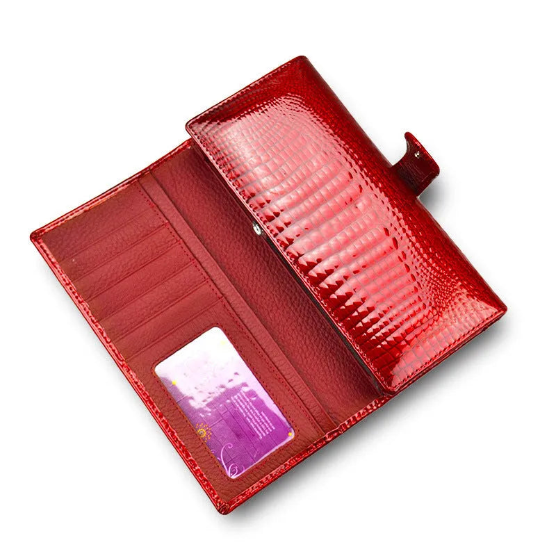 Women's leather purse with crocodile pattern design in wine red colour showing interior pigskin lining