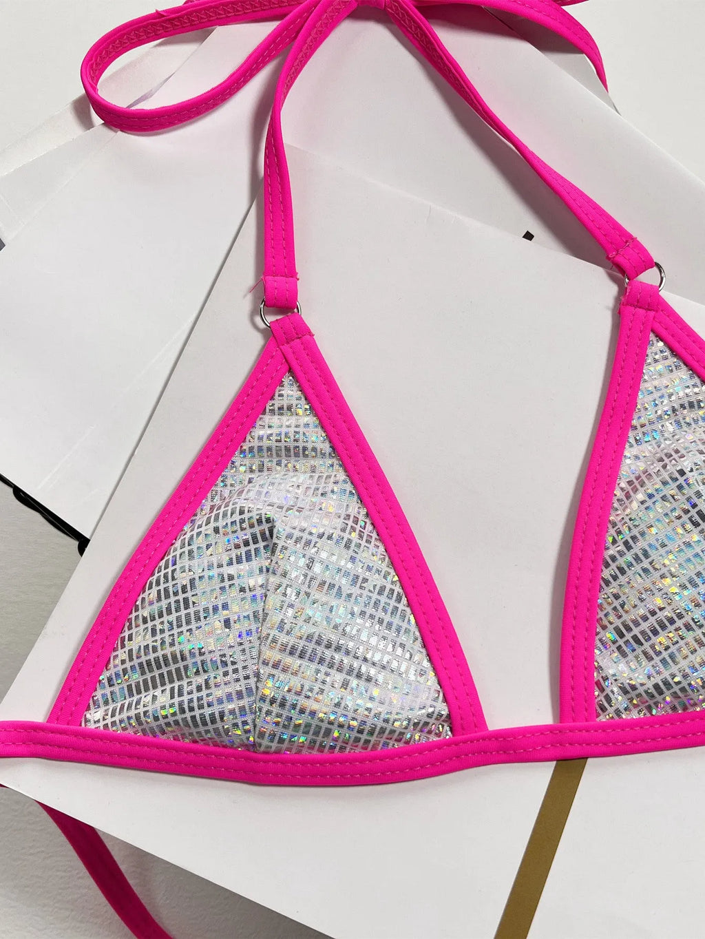 Solid silver women's triangle cut bikini swimsuit on a neutral background