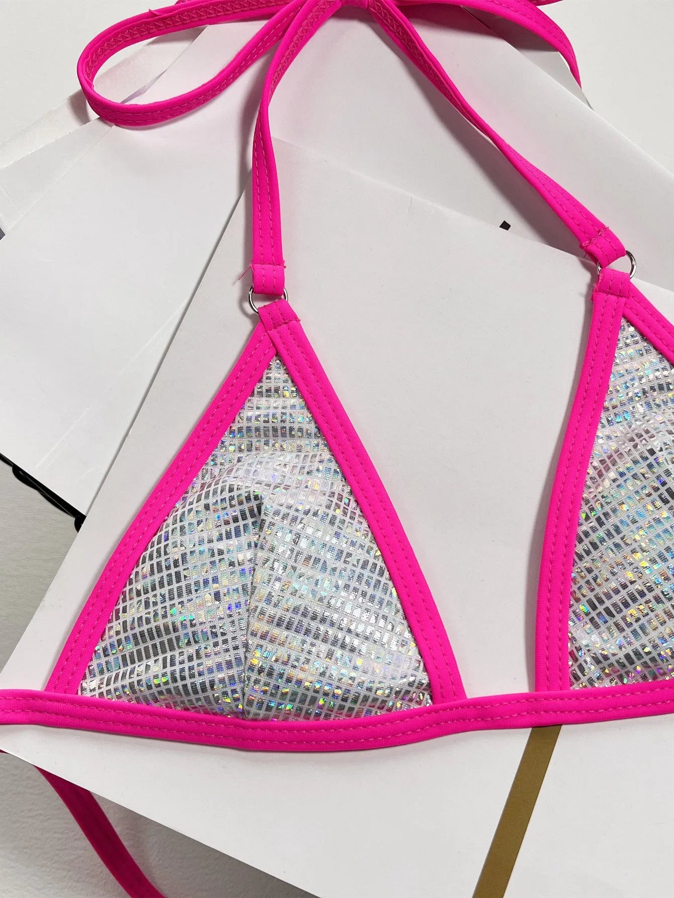 Solid silver women's triangle cut bikini swimsuit on a neutral background