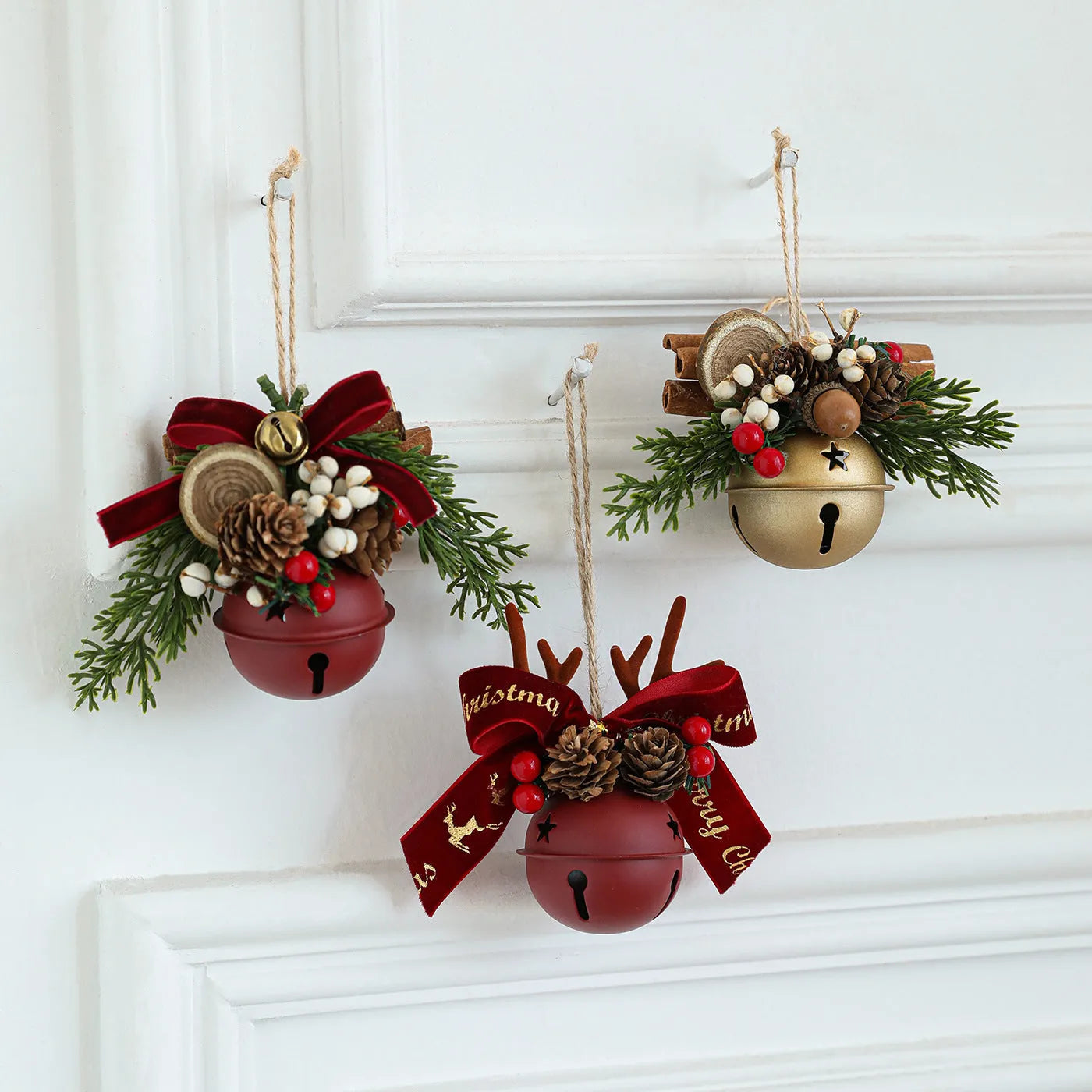 Wrought iron window hanging ornament with a jingling bell, antlers, and pine cone design in a choice of colours.