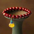 Gold cinnabar wave bracelet with solid copper beads in handcrafted national style design