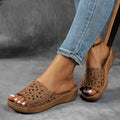 Women's black wedge beach slippers with flower cutout design and open fish mouth toe.