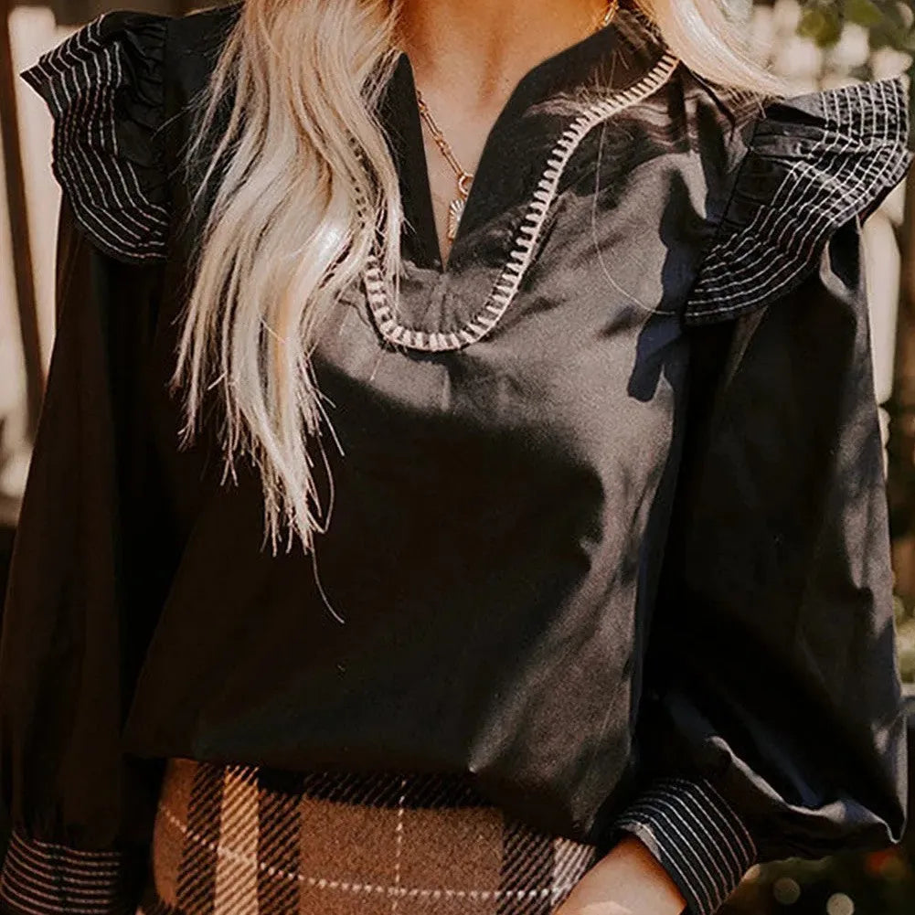 Black women's blouse with V-neck, contrast stitching, and three-quarter length ruffle sleeves