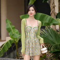 Women's floral one-piece swimsuit with suspender straps in green and pink colour options
