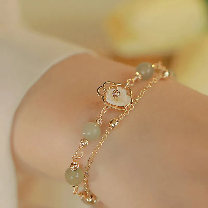 Yellow gold electroplated copper bracelet with butterfly charm and geometric shape for women.
