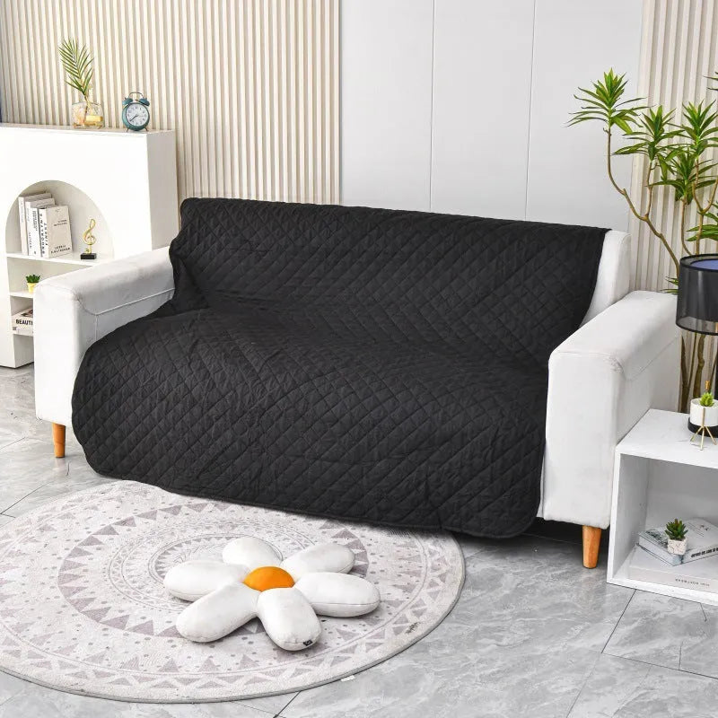 Reversible waterproof dog blanket sofa cover in grey, laid flat on a sofa