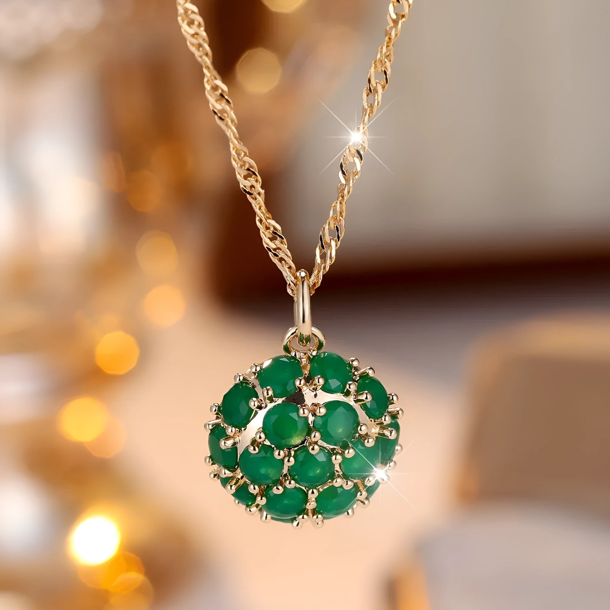 Champagne gold necklace with round emerald pendant and full diamond setting on an adjustable chain.
