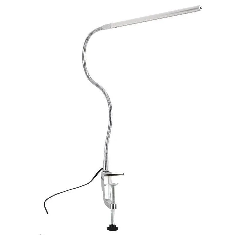 Silver aluminium alloy USB LED nail lamp with long arm and clip-on base, lit with bright white light.