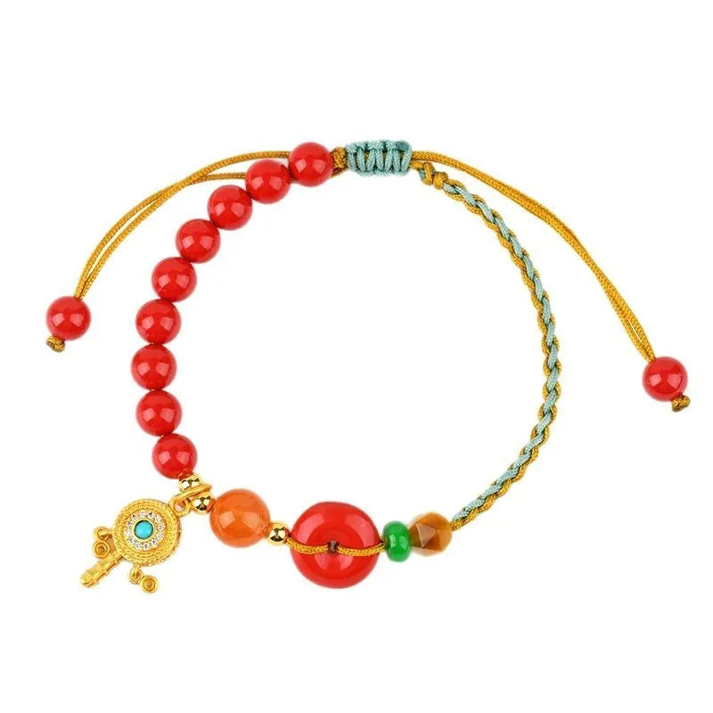 Hand-woven cinnabar bracelet with geometric peace blessing buckle in emperor red sand colour