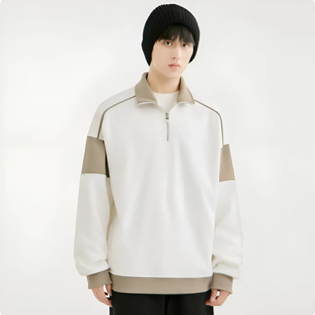 A man's grey hooded corduroy sweater with drop shoulders and loose lapels laid flat.