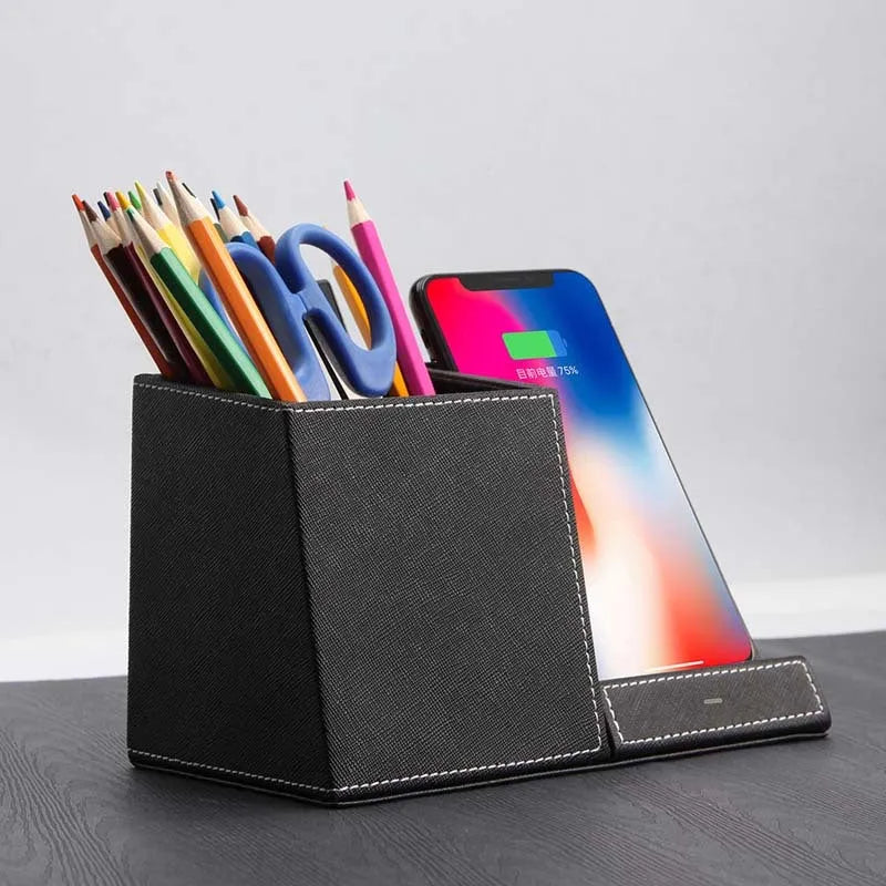 Black leather pen holder wireless charger on desk with phone charging and pens stored