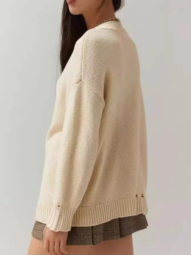 Women's acrylic jacquard pullover sweater in milky white with round neck and long sleeves, showing loose fit and textured pattern