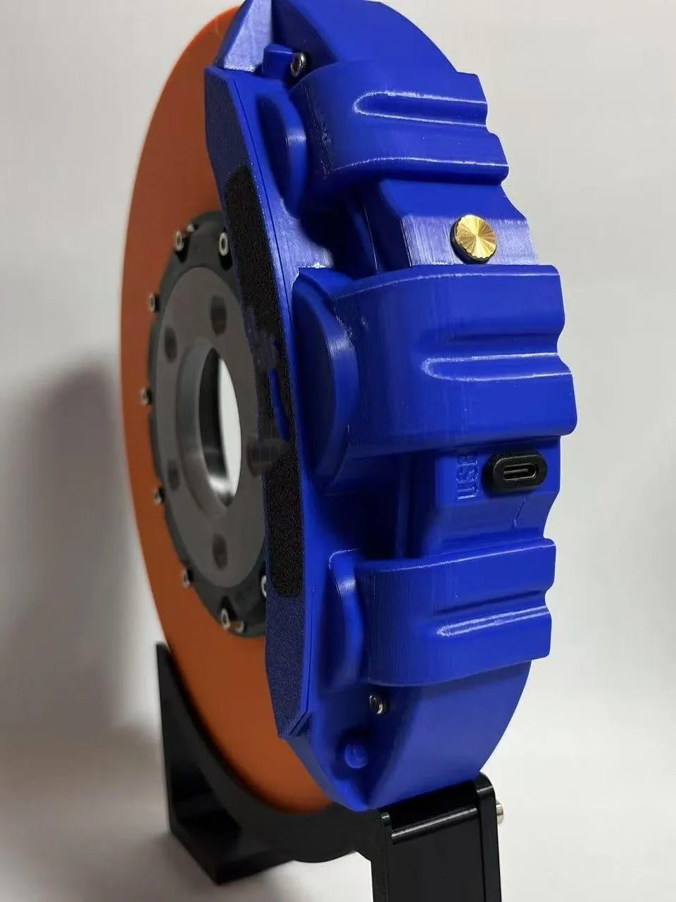 Blue brake disc LED rechargeable night light with touch dimmer on a desktop