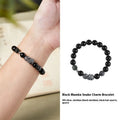 Men's retro snake bracelet in sterling silver with a large black obsidian stone on a dark background.