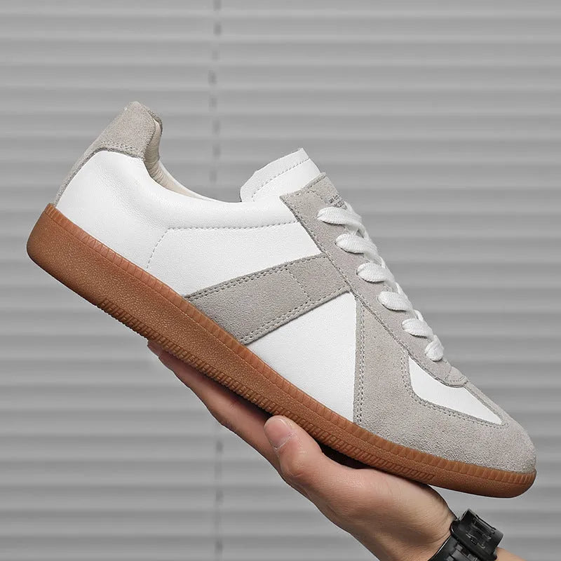 White Japanese-style retro unisex board shoes with lace-up front and round toe on a rubber sole.