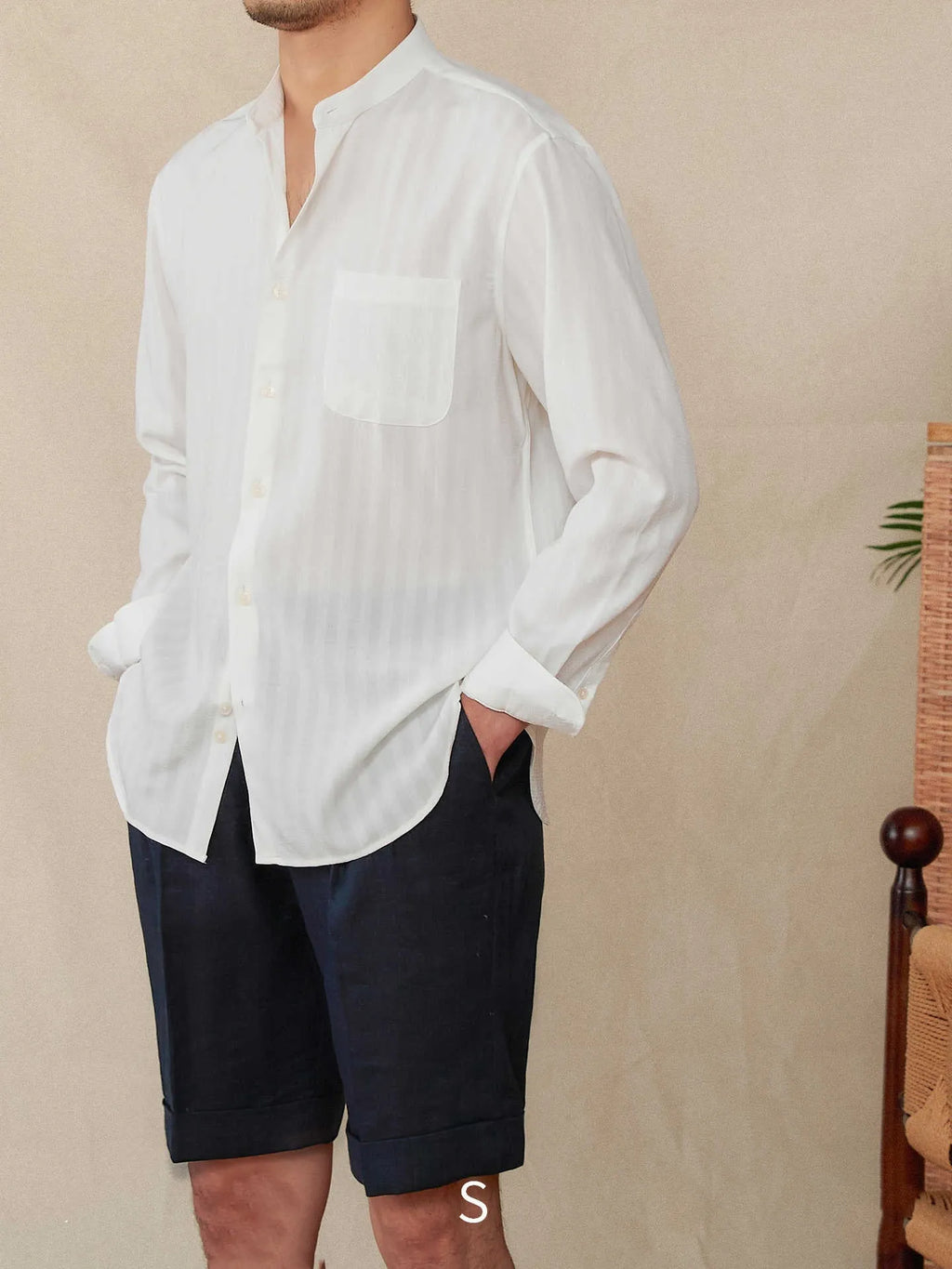 Blue and white seersucker striped long sleeve shirt with loose lapel collar on hanger