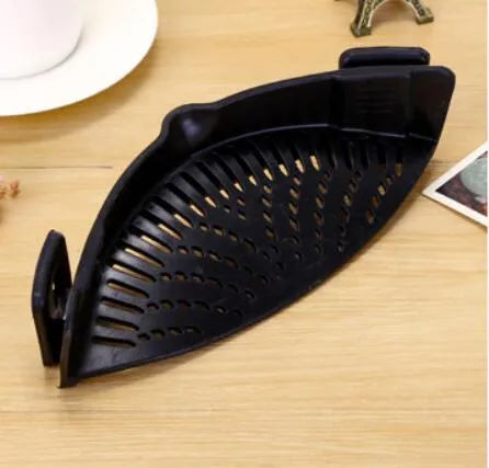 Silicone clip-on kitchen strainer with stainless steel mesh attached to pot rim for draining liquids