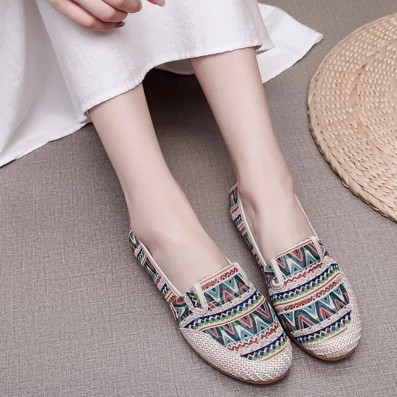 Women's ethnic style cloth shoes with flat heel, colour stitching, and a shallow mouth design.
