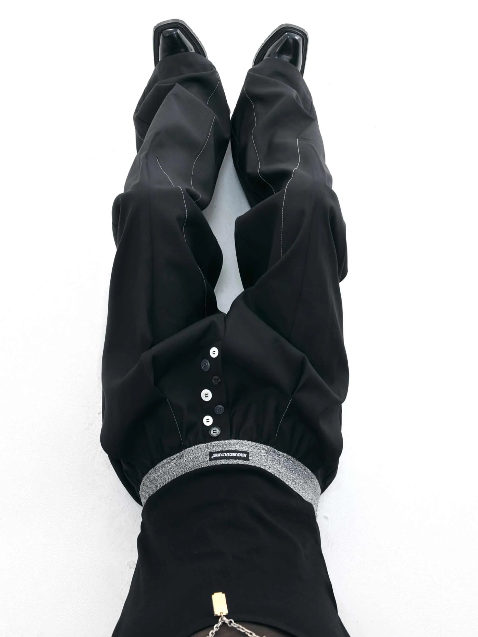 Straight-leg suit trousers in black with high waist and button-open line design, made from polyester-cotton blend.