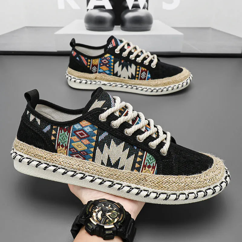 Men's round toe casual cloth shoes in beige and black on a plain background.