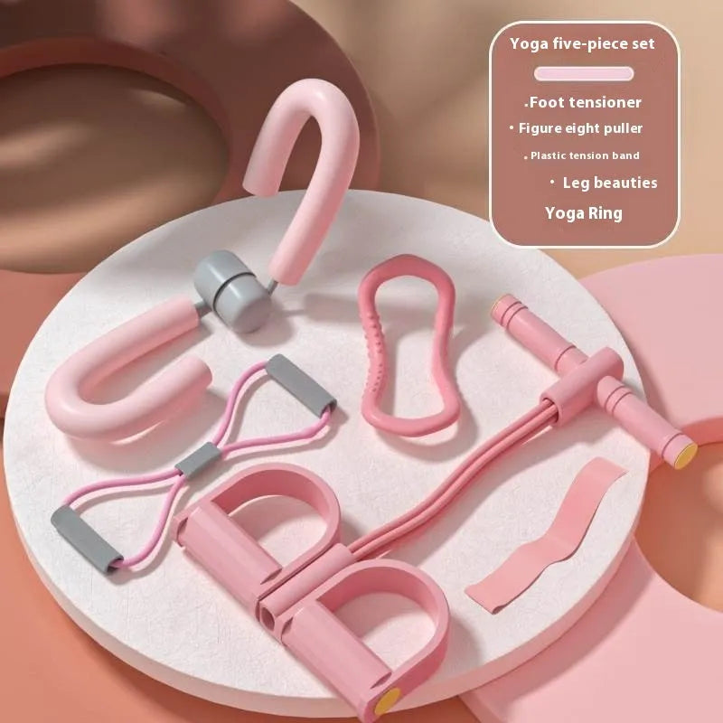 Yoga four piece set with leg stretching device, yoga ring, pedal tensioner, and figure eight tension rope on a mat