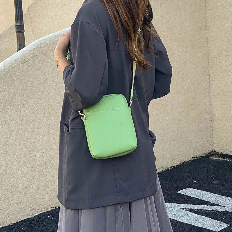 Solid colour mobile phone crossbody bag with adjustable strap, compact 14.5x5.5x19cm dimensions