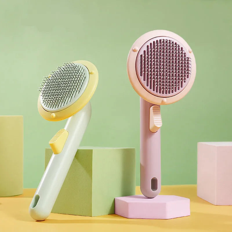 Pumpkin coloured hand-held pet grooming brush with stainless steel needles on a curved comb.