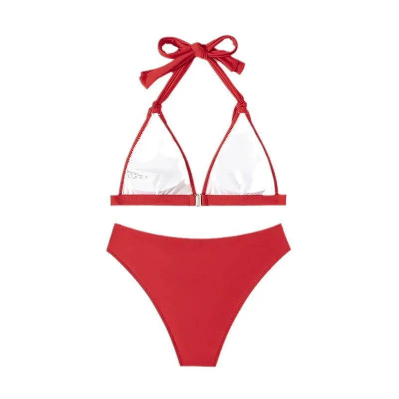 Red women's halterneck bikini with front lace-up detail and high-leg split shorts