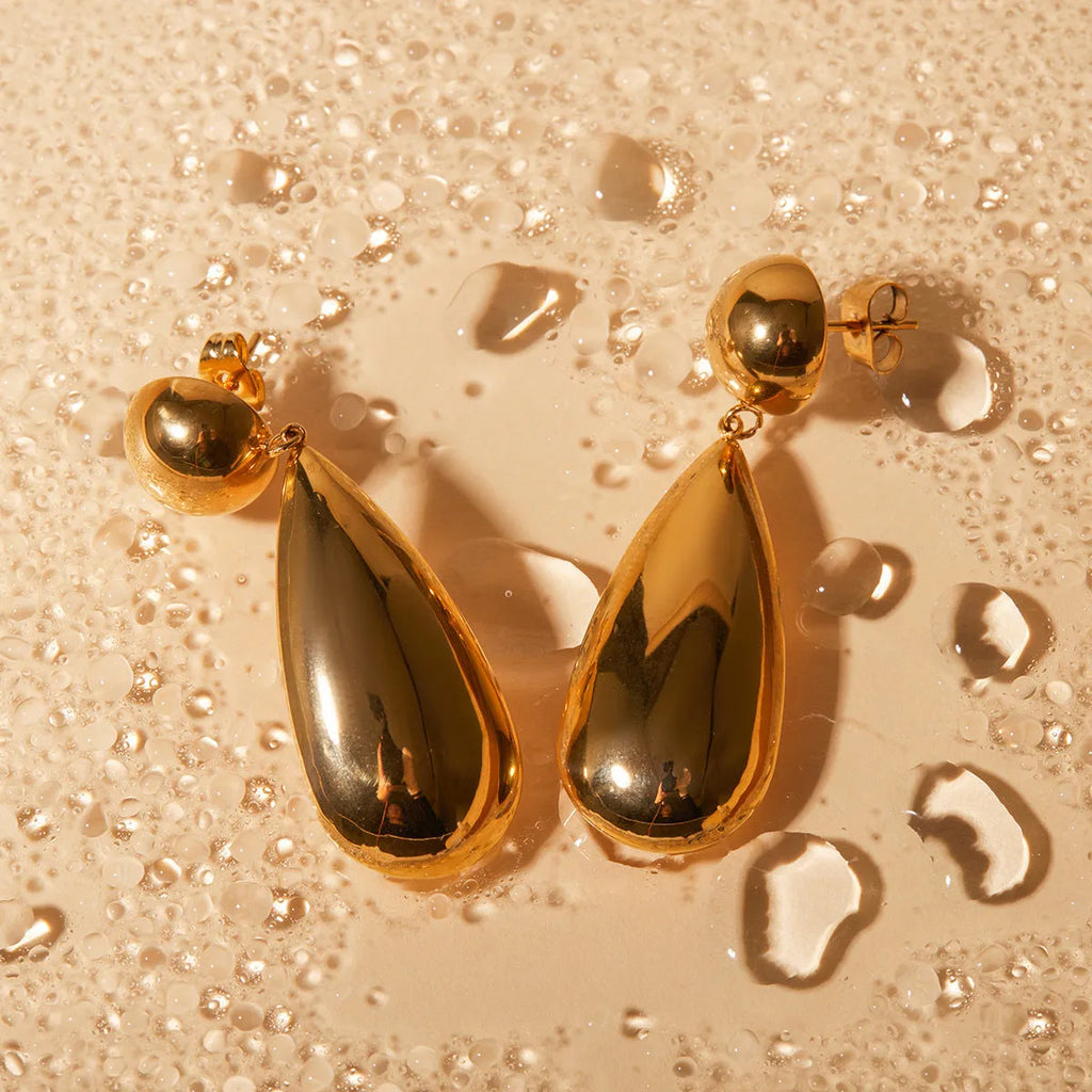 Gold electroplated stainless steel earrings with geometric hemisphere and water drop pendant design