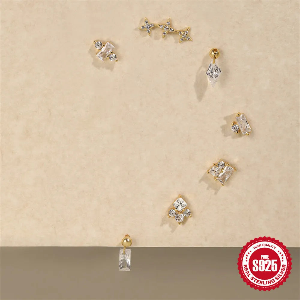Close-up of women's sterling silver flower stud earrings with square gravel texture in a gold colour.