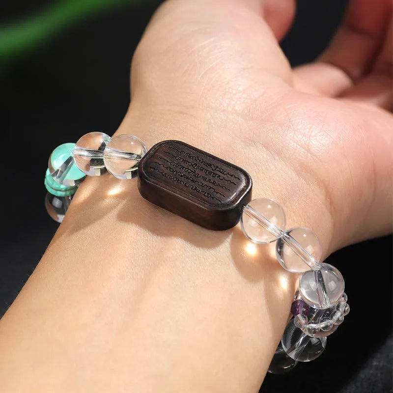 Natural white crystal ebony five warp bracelet on wrist showing wooden beads and ethnic design