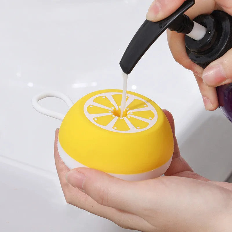 Yellow silicone pet bath brush with massage nodes and comb teeth on a white background.