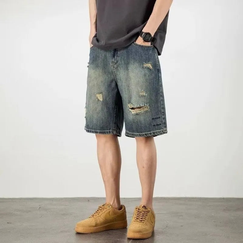 Blue retro-style men's denim shorts with a straight leg and slight distressing details on a neutral background.