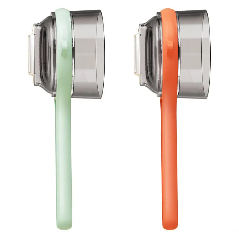Light green kitchen peeler with attached storage bucket for catching fruit and vegetable peelings
